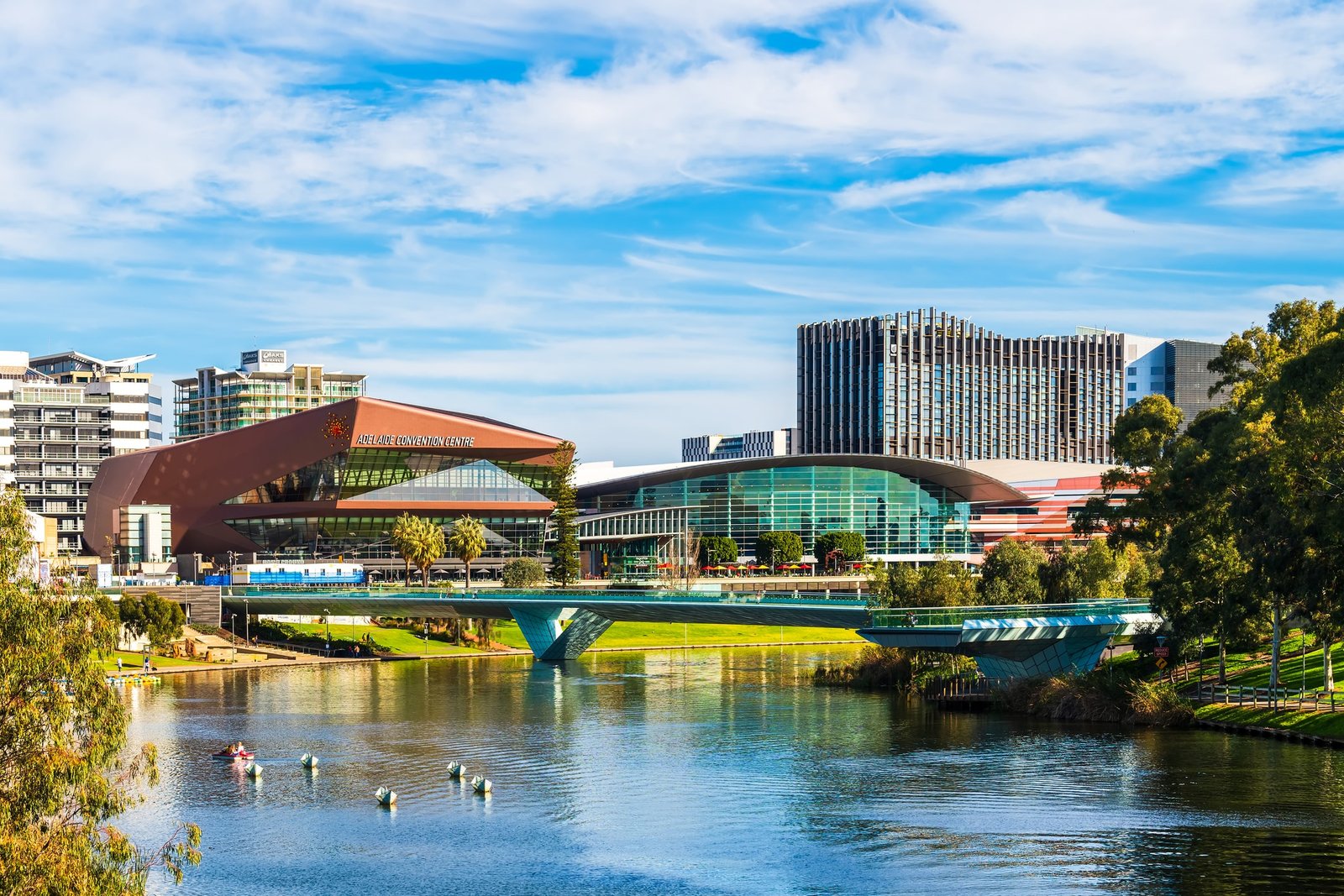 Adelaide city foot bridge across Torrens River with Adelaide Convention Centre and the University of Adelaide
